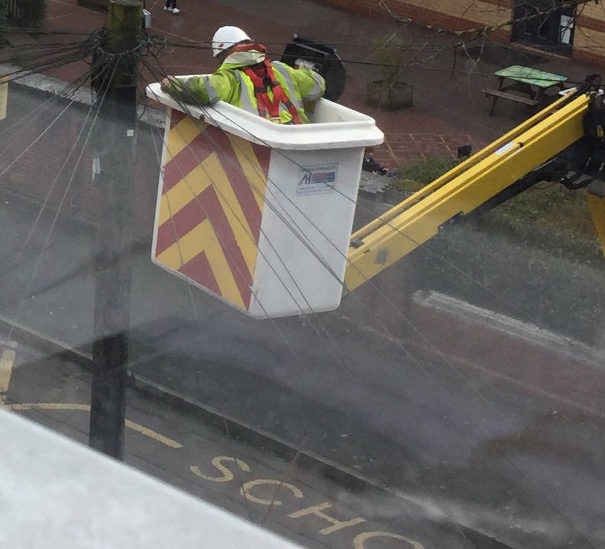 Engineer working on telephone lines from an elevated platform