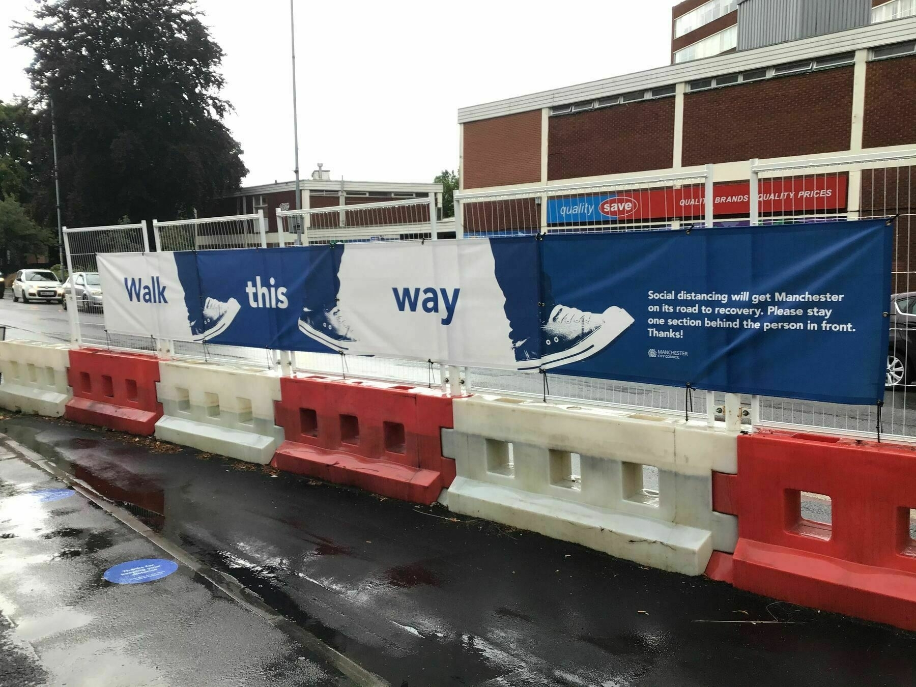 Road side banner asking pedestrians to maintain  a distance from others during the Covid Pandemic 2022