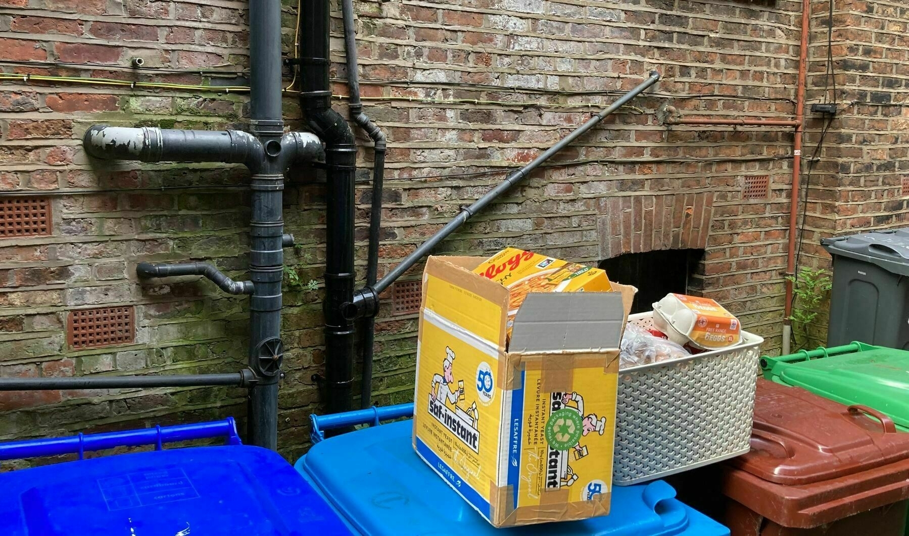 A selection of boxes atop recycling bins into which they will be deposited.